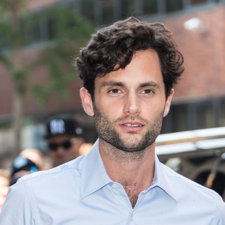Penn Badgley in a white shirt posing for a picture